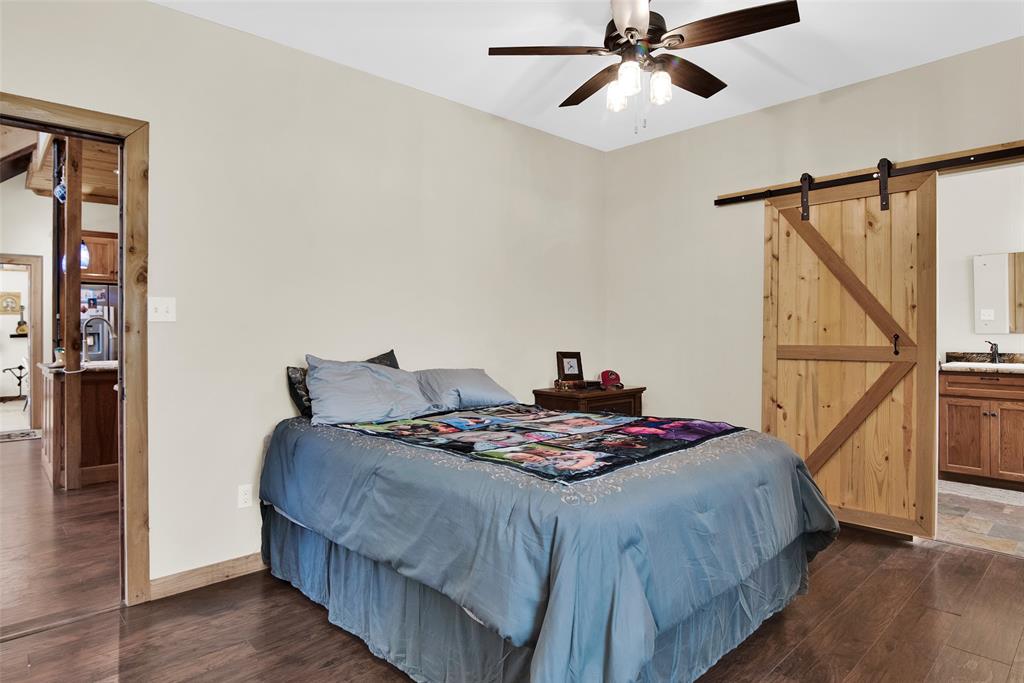 263 Esquire Drive Denison, TX 75021 - Photo 23 of 38 a bedroom with a bed and a chandelier