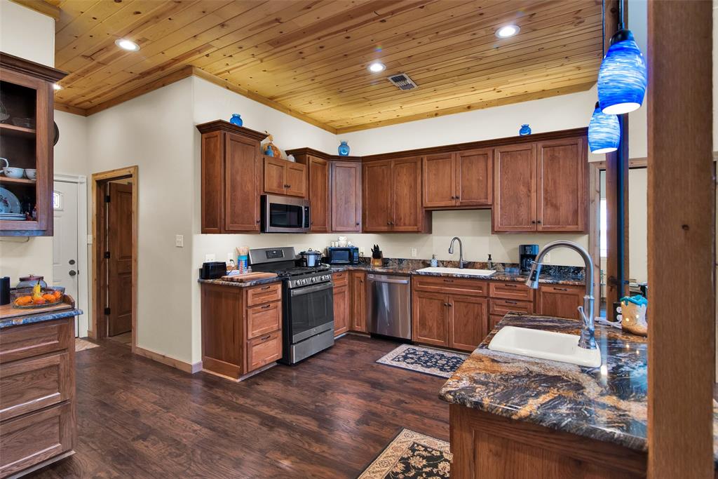 263 Esquire Drive Denison, TX 75021 - Photo 27 of 38 a kitchen with stainless steel appliances granite countertop a stove sink and cabinets