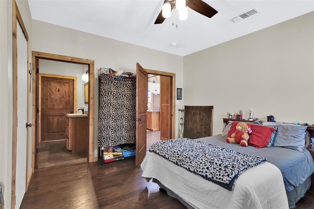 263 Esquire Drive Denison, TX 75021 - Photo 30 of 38 a bedroom with a bed and a chandelier