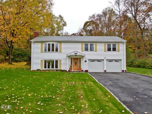 66 Longmeadow Road Shelton, CT 06484 - Photo 1 of 1 a front view of a house with a garden and trees