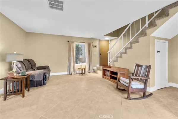 a living room with furniture and a piano