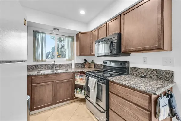 a kitchen with a stove sink and microwave