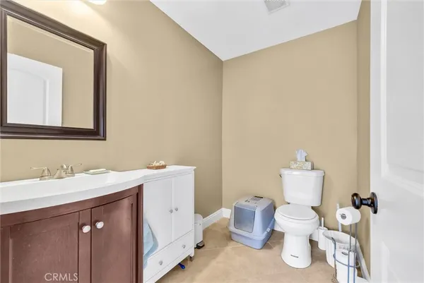 a white toilet sitting next to a bathroom sink