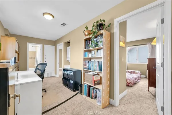 a bedroom with furniture and a book shelf