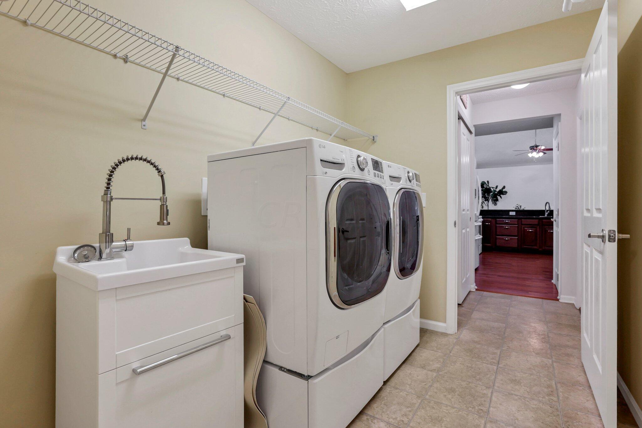 4223 Cobbler Road, Unit 16422 New Albany, OH 43054 - Photo 31 of 36 Laundry/mudroom off of garage with utility sink. Washer & Dryer stay.