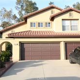 a front view of a house with a garage