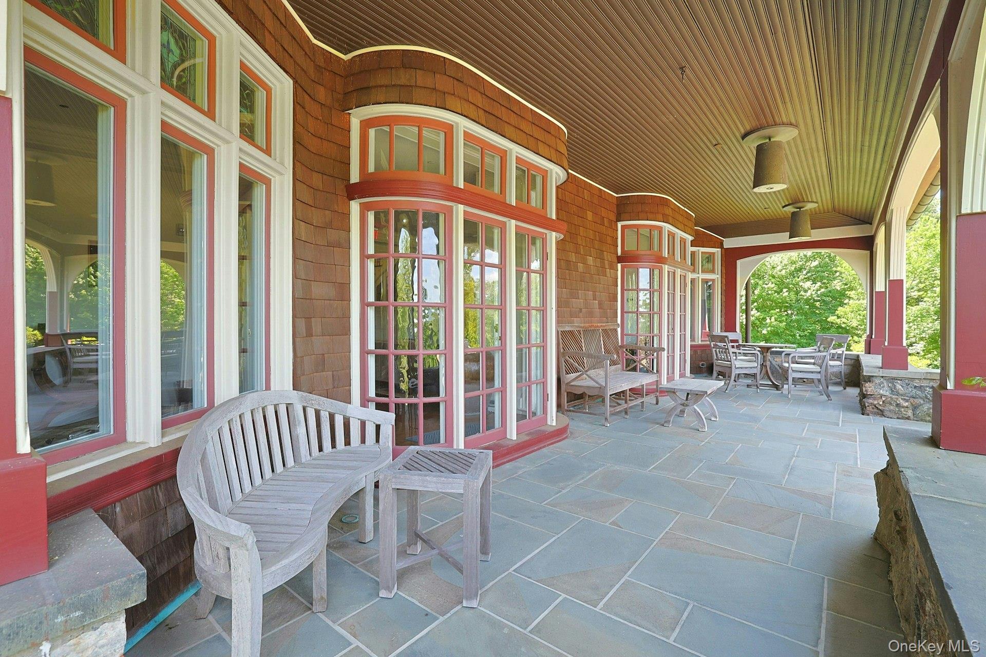 20 Nazareth Way Cold Spring, NY 10516 - Photo 36 of 50 The deep and wide slate front porch is an entertainer's dream. After dinner, the party can move out to this covered space. Pick any of the many seating areas that overlook the grounds and watch as the sun sets over the highlands in the distance.