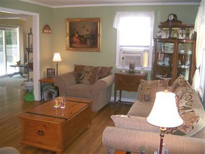 274 Simon Narrows Road Mashpee, MA 02649 - Photo 2 of 28 a living room with furniture and a fireplace