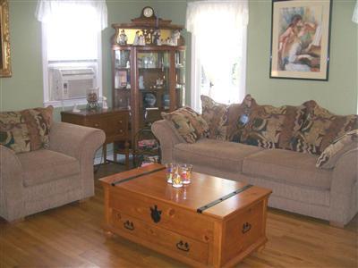 274 Simon Narrows Road Mashpee, MA 02649 - Photo 3 of 28 a living room with furniture and a chandelier