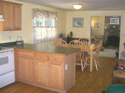 274 Simon Narrows Road Mashpee, MA 02649 - Photo 7 of 28 a kitchen with granite countertop a table chairs stove and sink