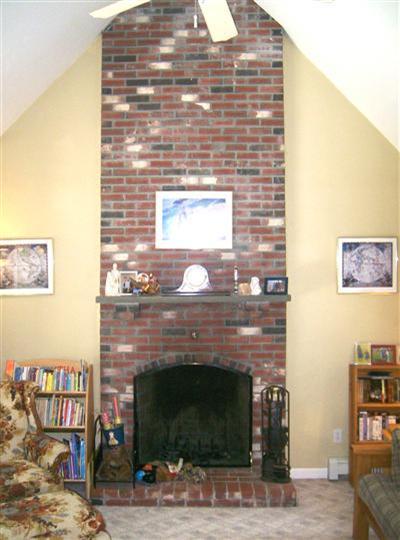 274 Simon Narrows Road Mashpee, MA 02649 - Photo 9 of 28 a fireplace with a vase on top of it