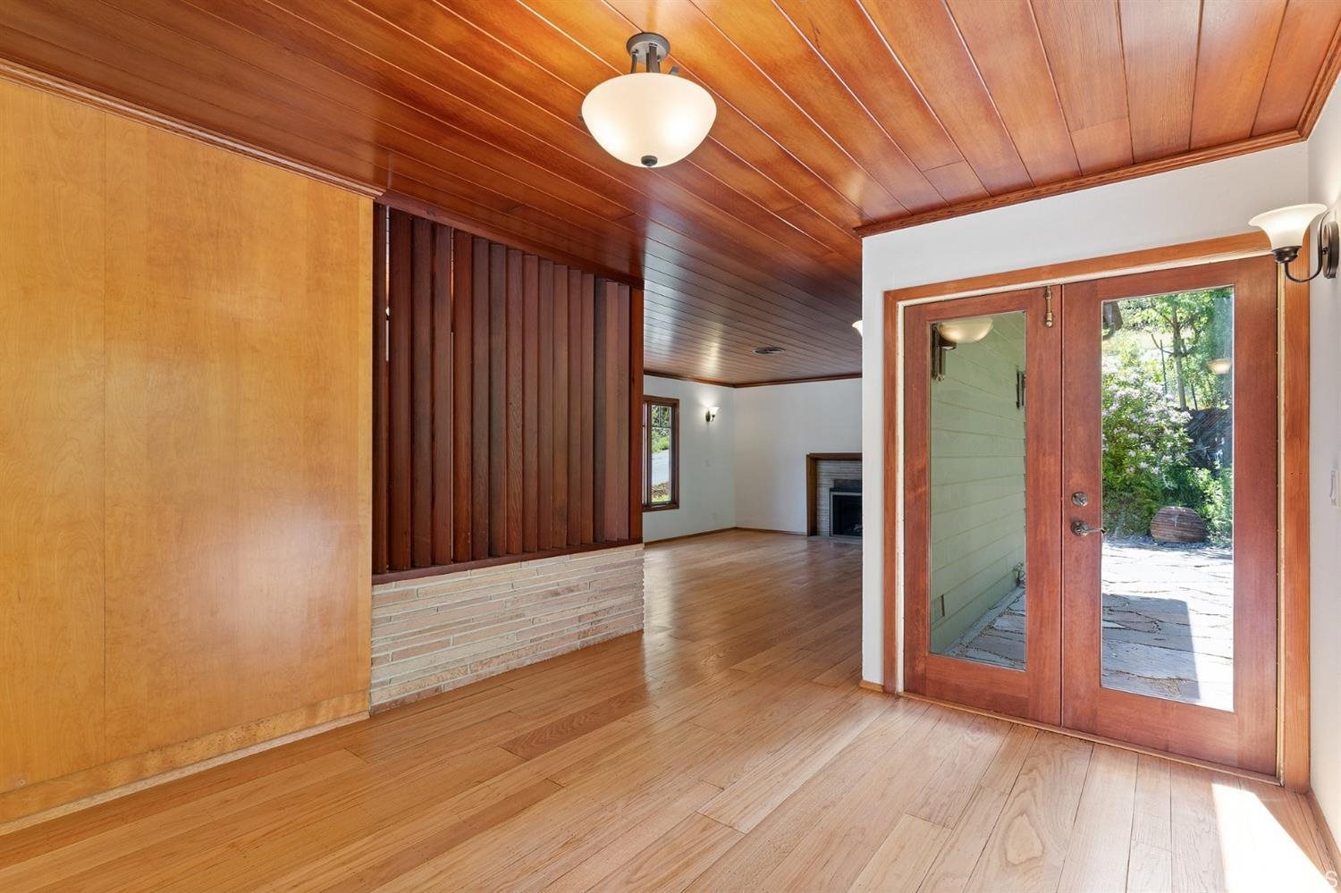 1180 Park Hills Road Berkeley, CA 94708 - Photo 14 of 62 a view of an empty room with wooden floor and a window