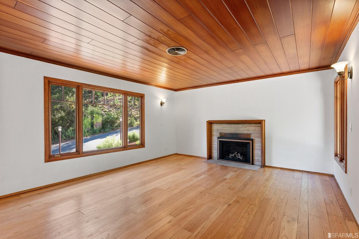 1180 Park Hills Road Berkeley, CA 94708 - Photo 17 of 62 a view of empty room with wooden floor and fireplace