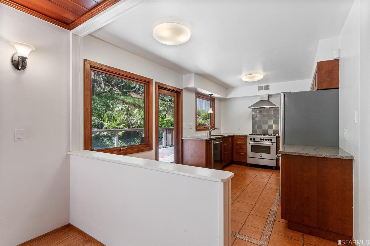 1180 Park Hills Road Berkeley, CA 94708 - Photo 22 of 62 a kitchen with stainless steel appliances a refrigerator and a stove