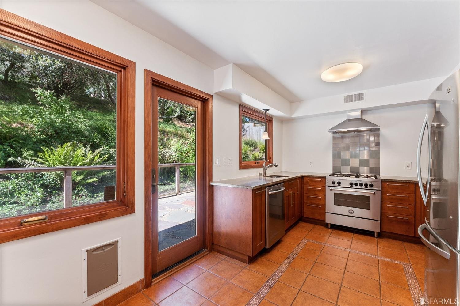 1180 Park Hills Road Berkeley, CA 94708 - Photo 23 of 62 a kitchen with stainless steel appliances granite countertop a stove and a refrigerator