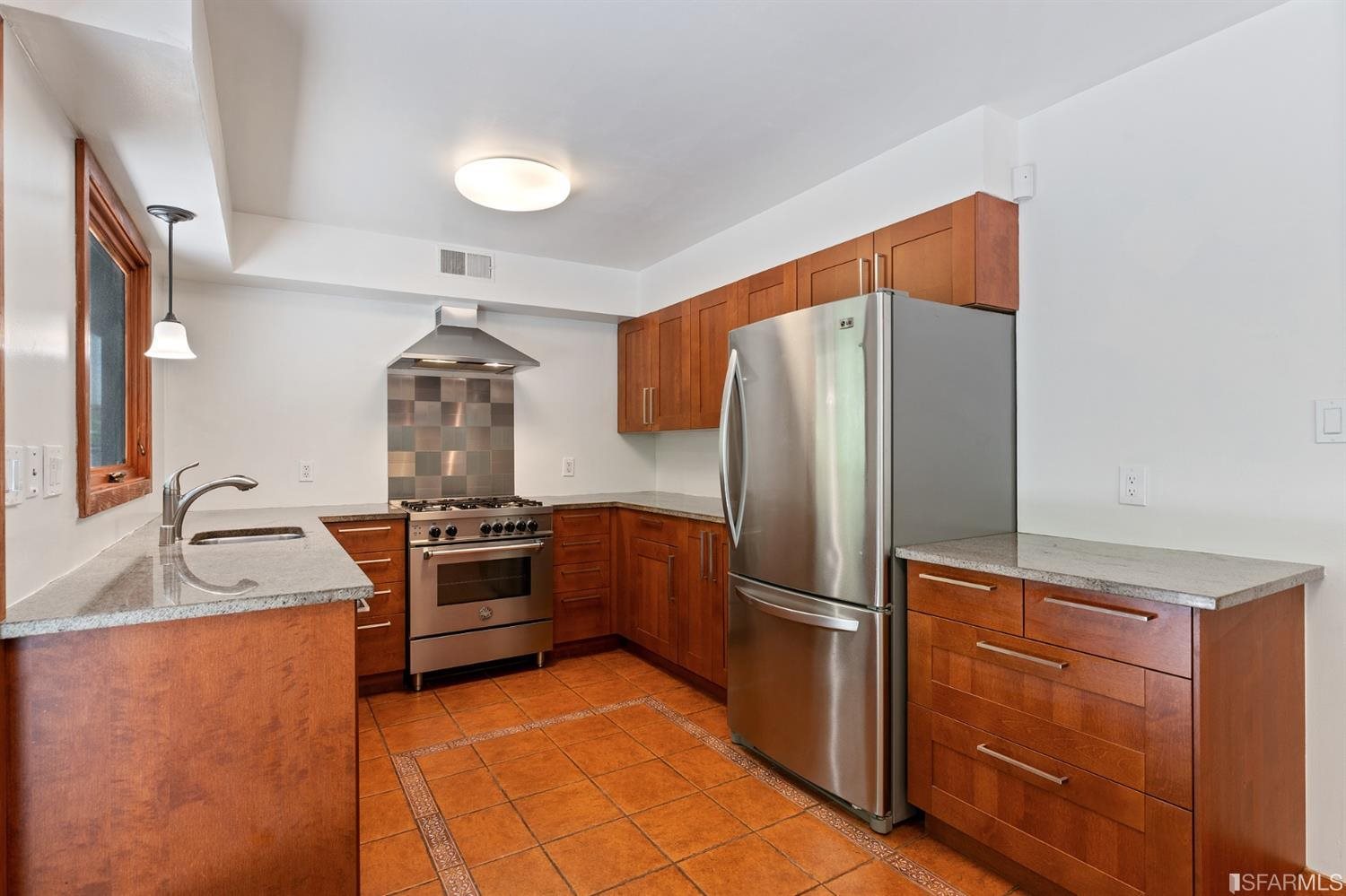 1180 Park Hills Road Berkeley, CA 94708 - Photo 24 of 62 a kitchen with granite countertop a refrigerator and a sink