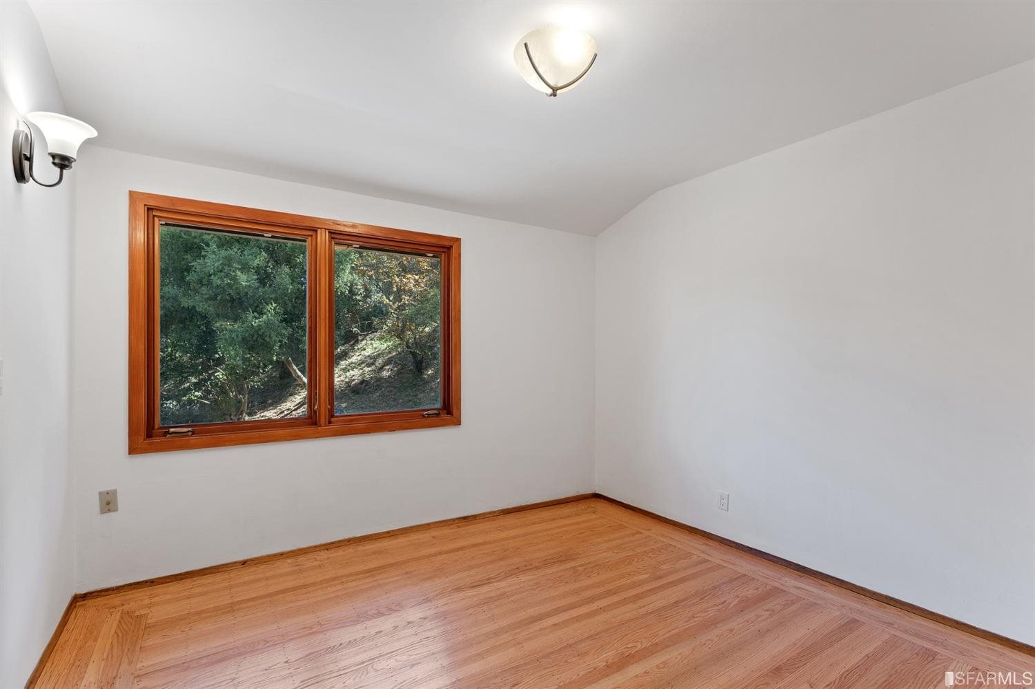 1180 Park Hills Road Berkeley, CA 94708 - Photo 27 of 62 a view of an empty room with wooden floor and a window