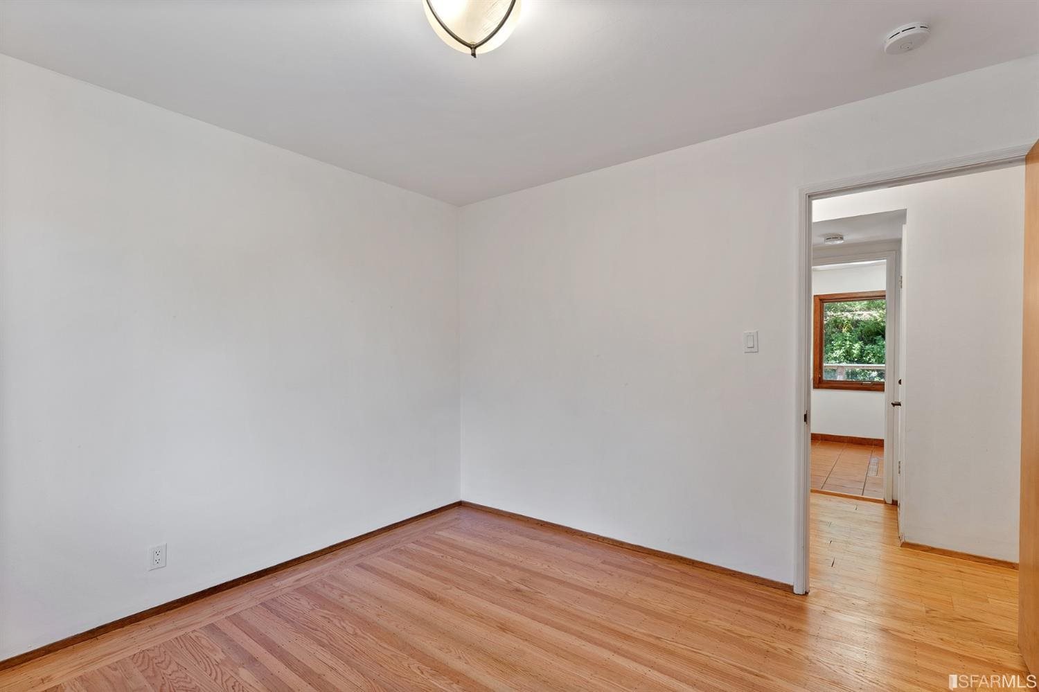 1180 Park Hills Road Berkeley, CA 94708 - Photo 29 of 62 a view of an empty room with wooden floor and a window