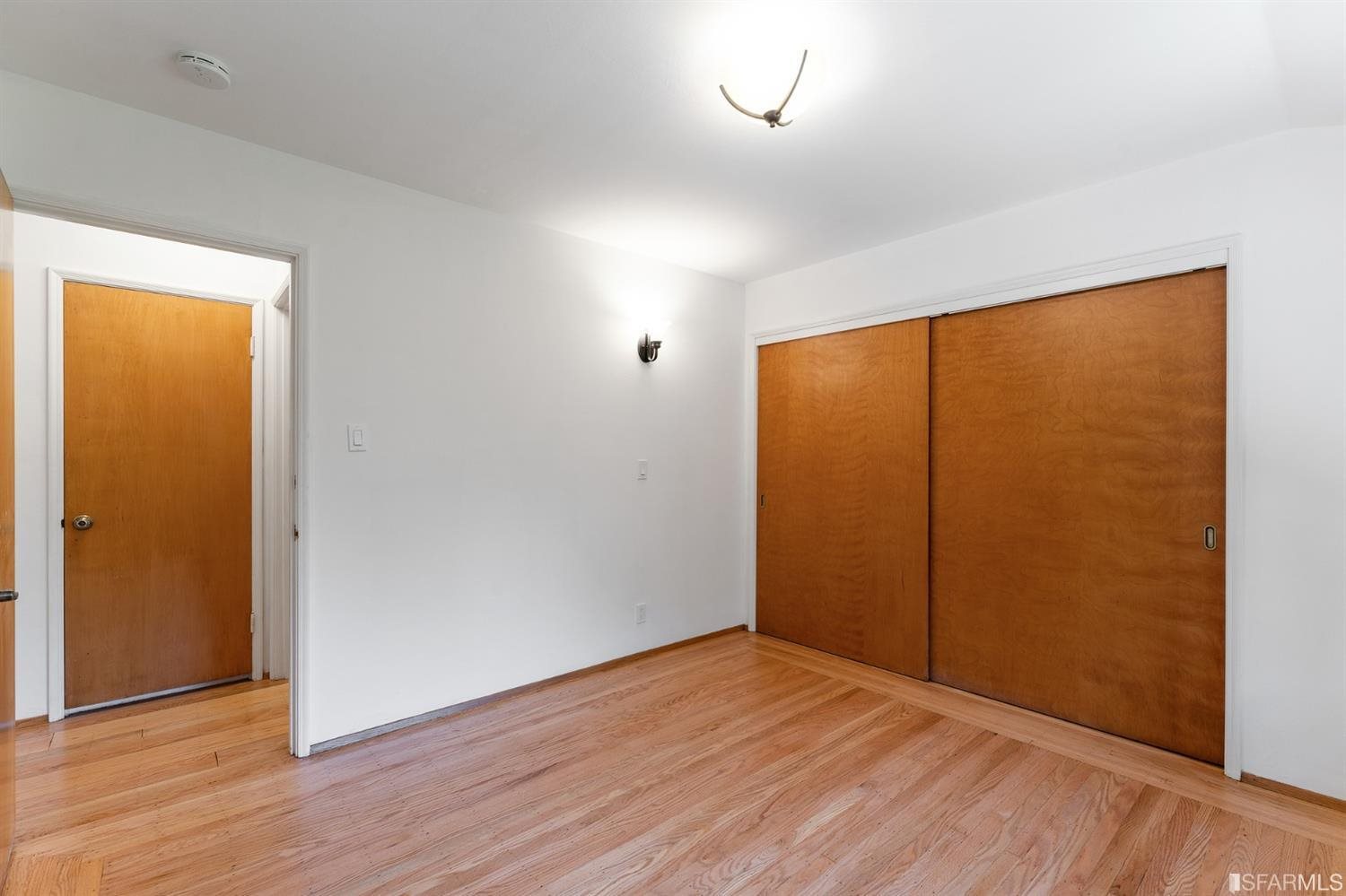 1180 Park Hills Road Berkeley, CA 94708 - Photo 33 of 62 an empty room with wooden floor and windows