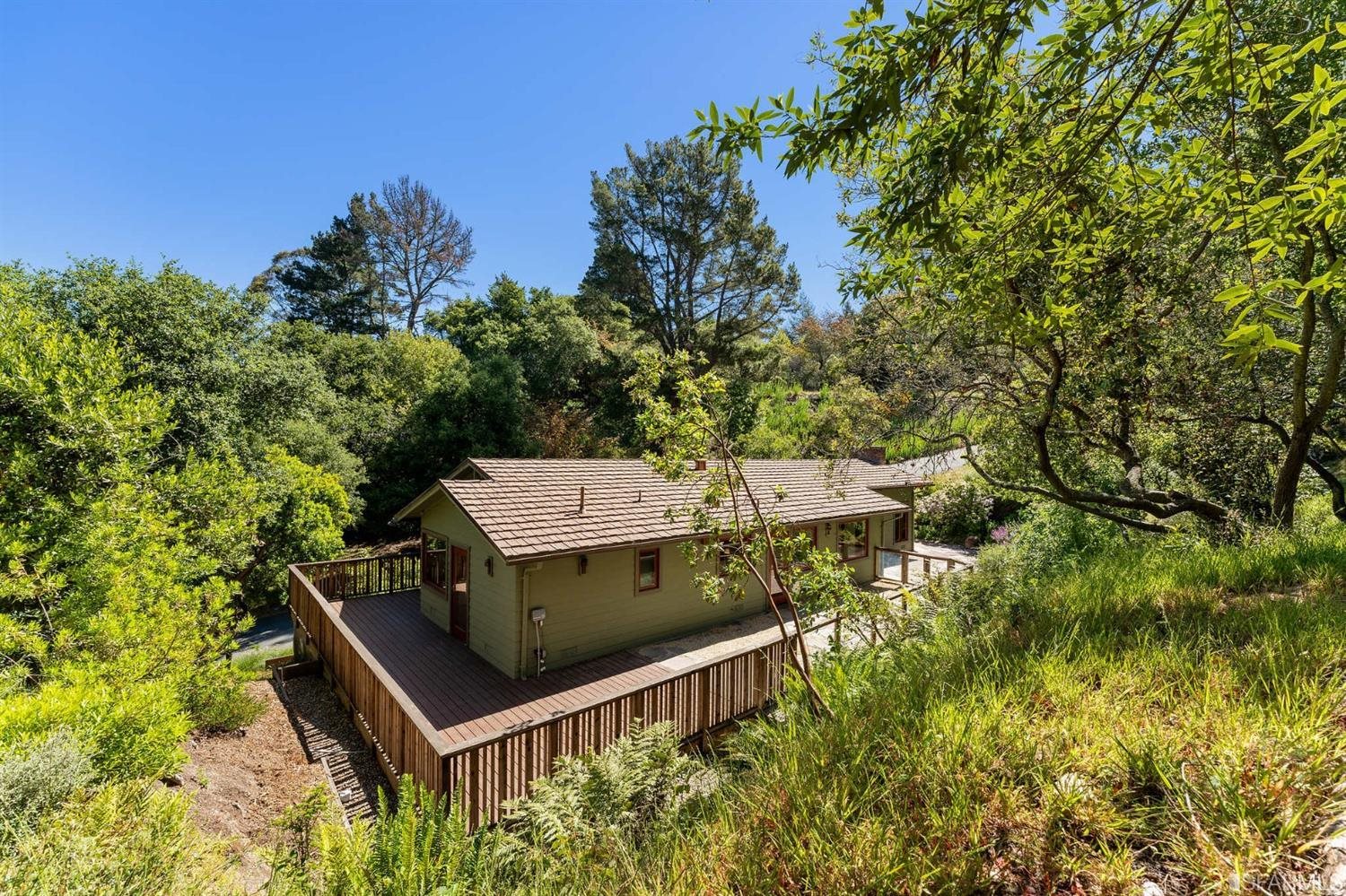 1180 Park Hills Road Berkeley, CA 94708 - Photo 56 of 62 an aerial view of a house with swimming pool and lawn chairs under an umbrella