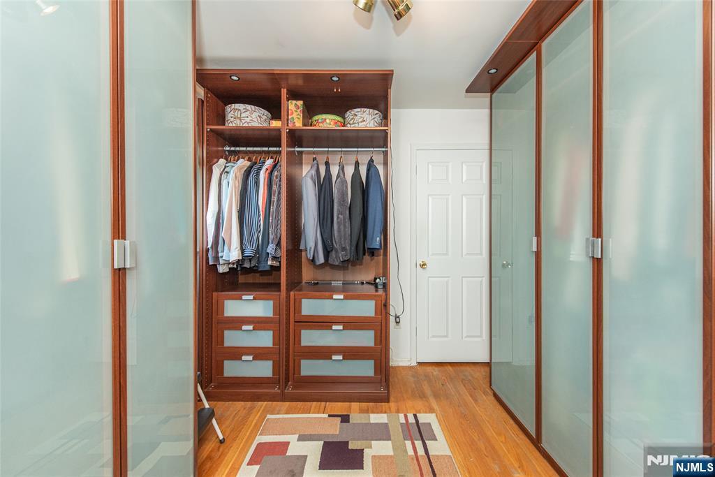 12 Abbott Road Wayne, NJ 07470 - Photo 23 of 49 a view of walk in closet with clothes and shoes