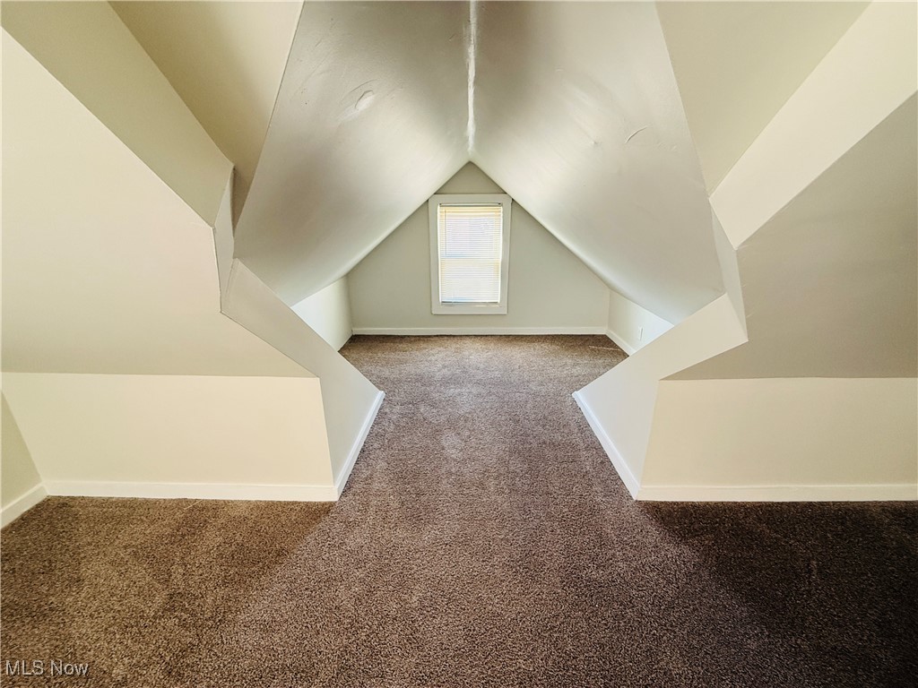 5239 Arch Street Maple Heights, OH 44137 - Photo 11 of 25 Bonus room with carpet floors and vaulted ceiling