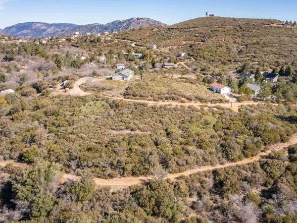 a view of a large building with mountains in the background
