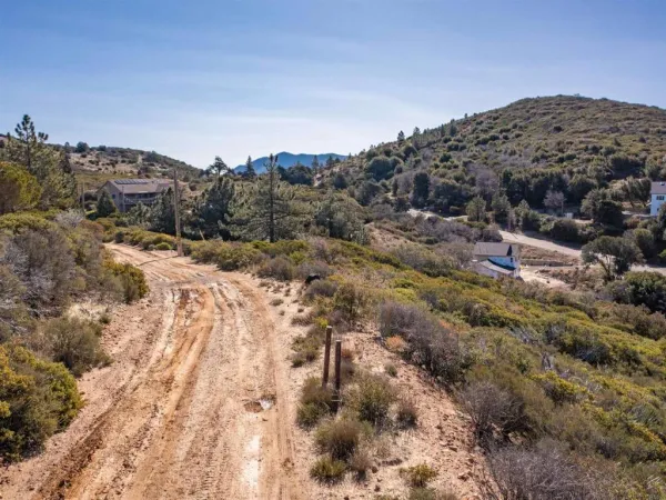 a view of a large building with mountains in the background