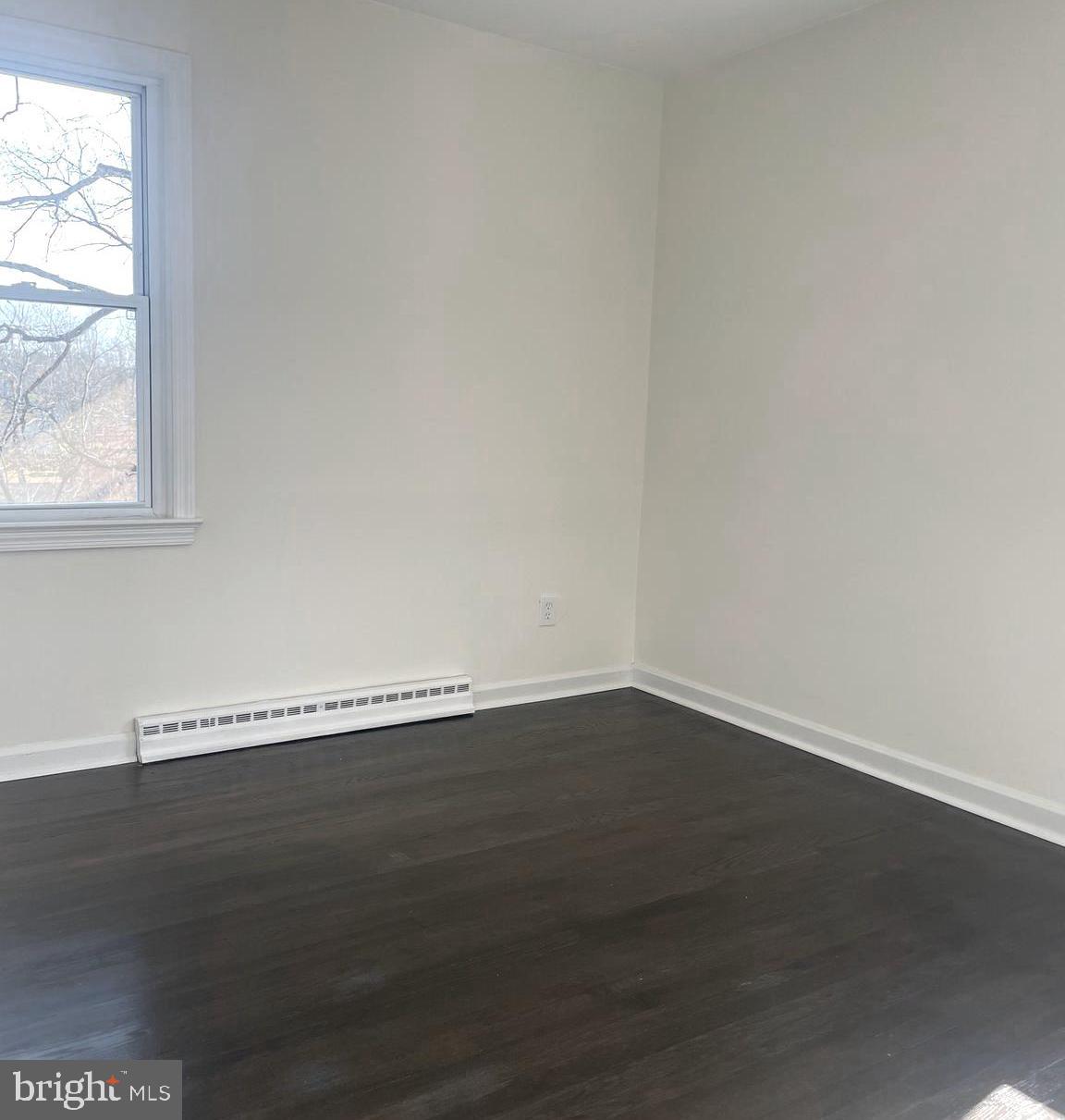 6107 Buckler Road Clinton, MD 20735 - Photo 18 of 45 an empty room with wooden floor and window