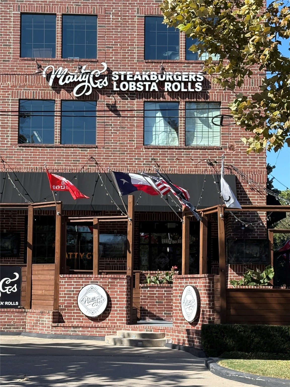 643 East 10th Street Houston, TX 77008 - Photo 24 of 28 a view of a brick house with a small yard and large tree