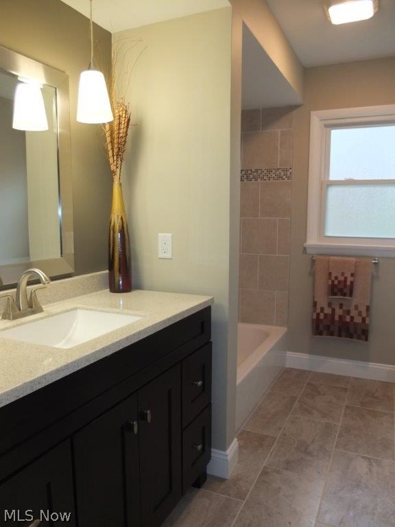 4262 Springdale Road Uniontown, OH 44685 - Photo 12 of 20 Remodeled full bath on the upper level with new vanity, solid surface countertop, tile flooring and shower surround.