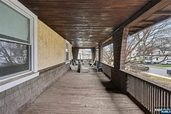 a view of a hallway with wooden floor and closet area
