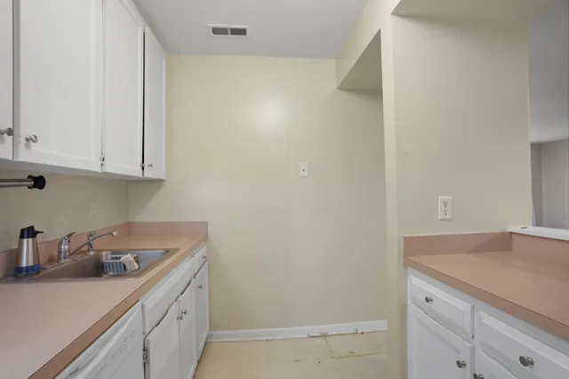 a kitchen with a sink and cabinets