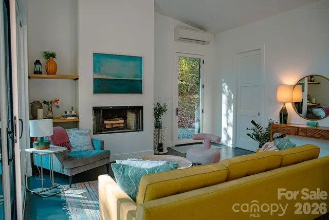 a living room with furniture and a fireplace