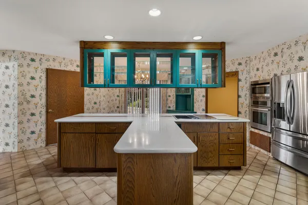 a kitchen with stainless steel appliances granite countertop a sink and a stove