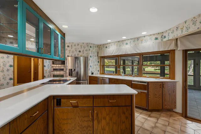 a kitchen with a granite countertop sink and window