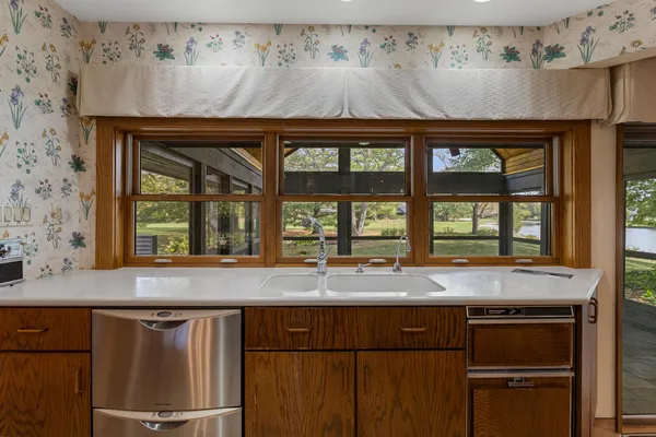 a kitchen with refrigerator and cabinets