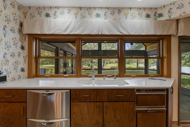 a kitchen with refrigerator and cabinets