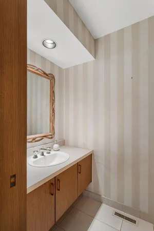 a spacious bedroom with a bed and glass window