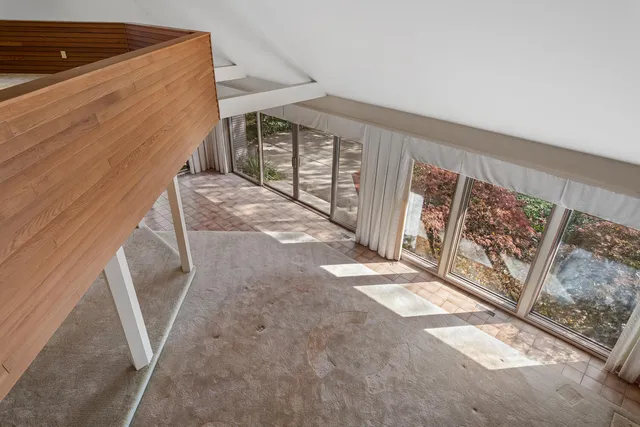 a room with furniture and a ceiling fan