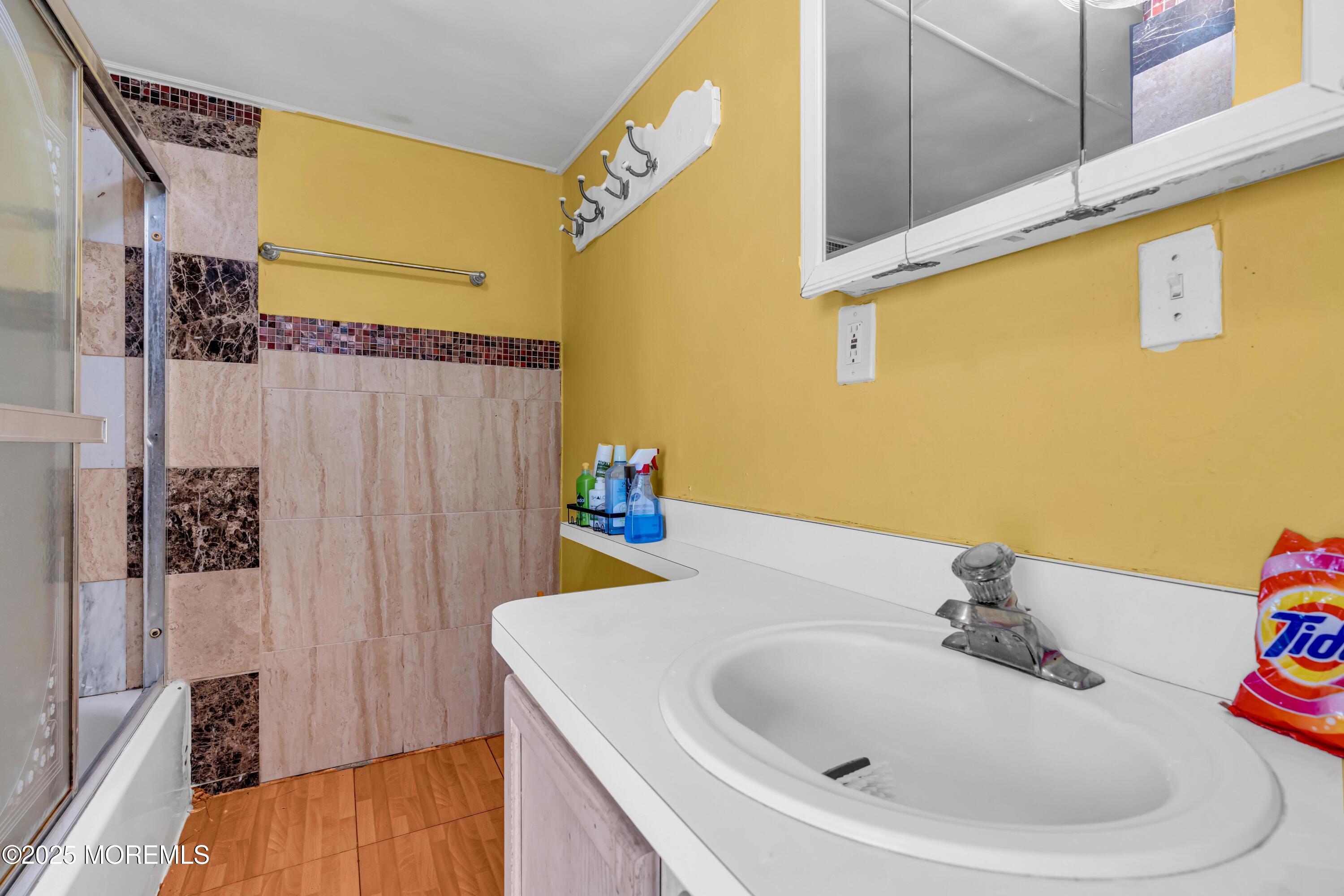 21 Bowne Avenue Freehold, NJ 07728 - Photo 9 of 25 a bathroom with a sink and a mirror