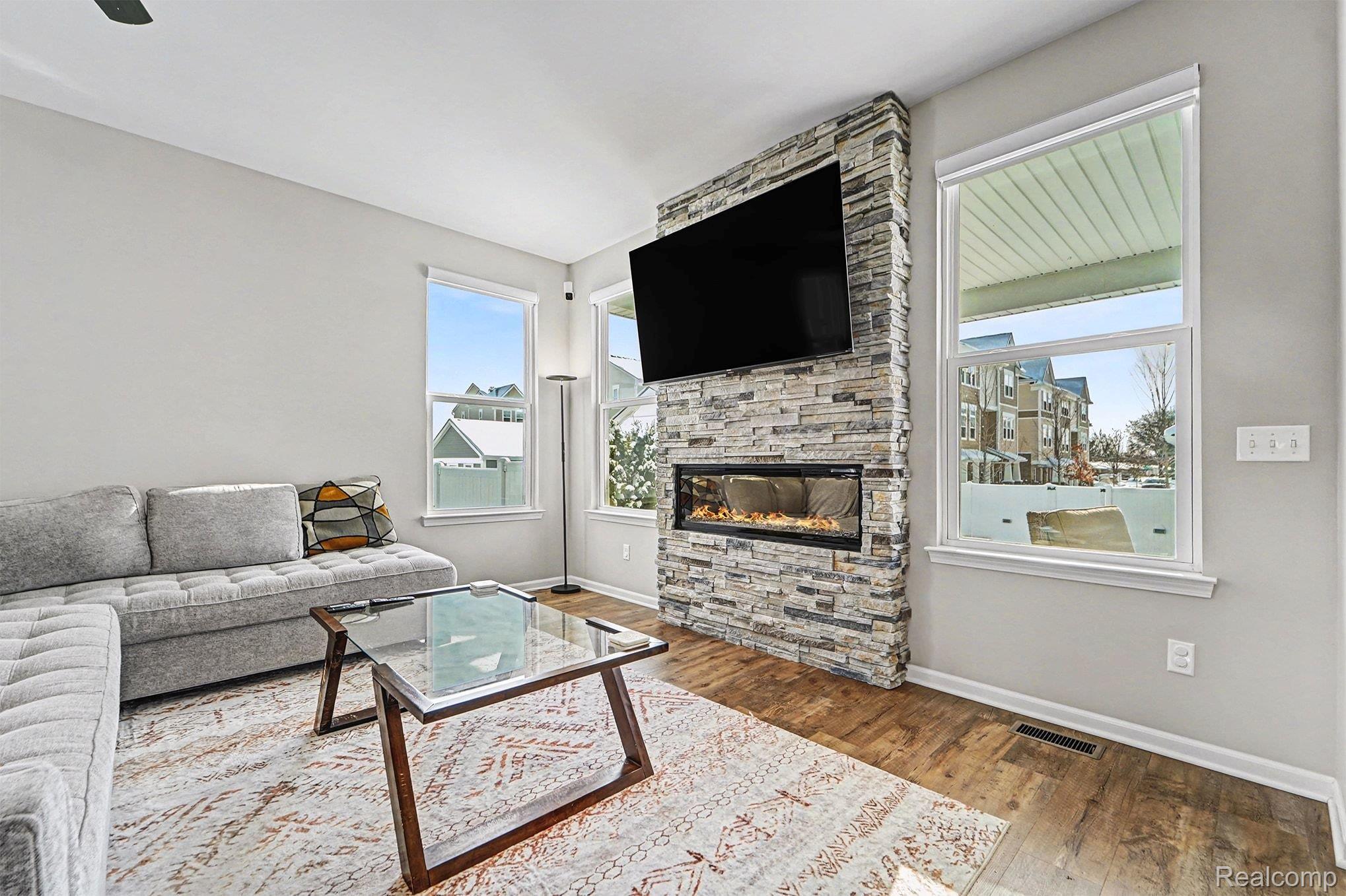 2471 Massoit Road Royal Oak, MI 48073 - Photo 9 of 49 Living room featuring wood finished floors and a stone fireplace