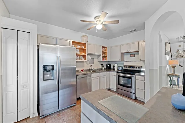 a kitchen with stainless steel appliances granite countertop a stove a refrigerator and a refrigerator
