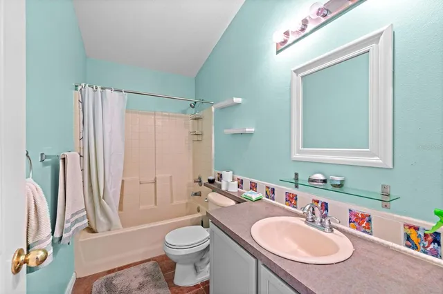 a bathroom with a sink toilet a mirror and shower