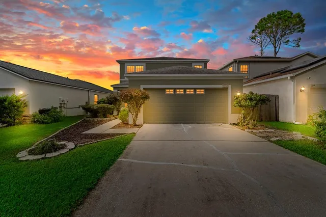 a front view of a house with a yard and garage