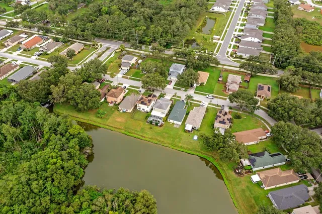 an aerial view of a residential houses with outdoor space and street view