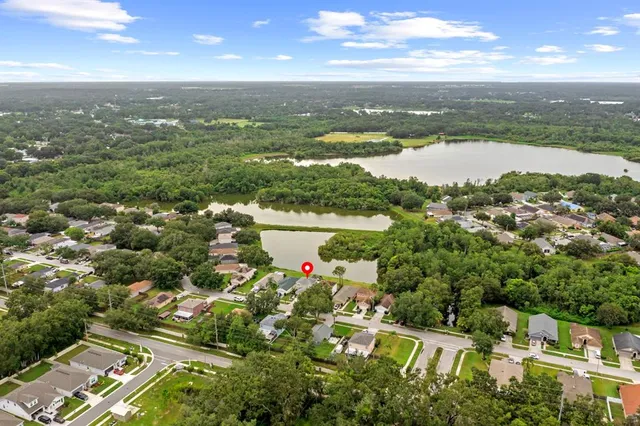 an aerial view of residential houses with outdoor space and ocean view