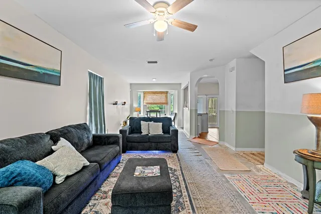 a living room with furniture and a chandelier