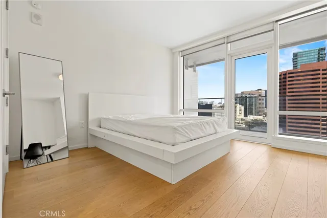 a spacious bedroom with a bed and a large window