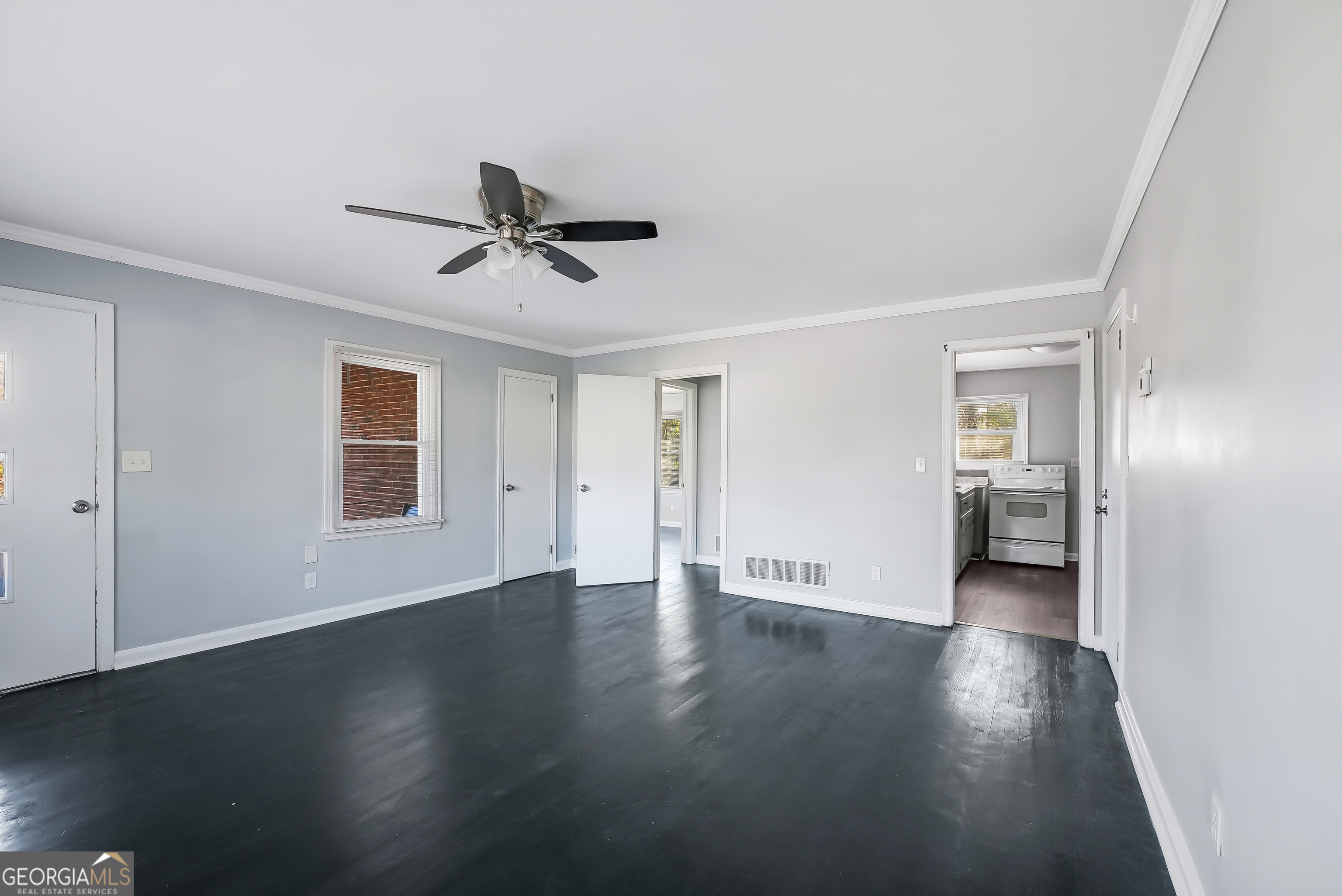 147 Burnside Street, Unit 4 Jonesboro, GA 30236 - Photo 3 of 9 a view of a livingroom with wooden floor and a ceiling fan